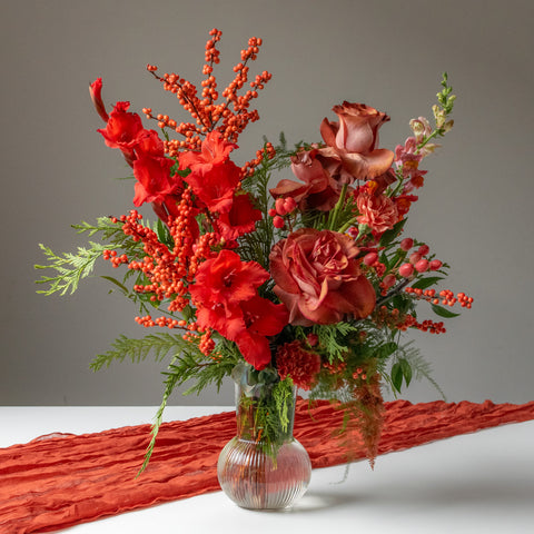 Tall and bright red flowers with winter greens.